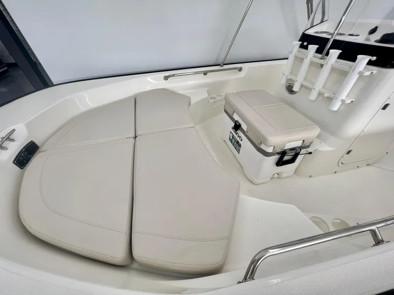 Slide: The Image of 2025 Boston Whaler 170 Montauk boat interior with cushioned seating and storage. - 8