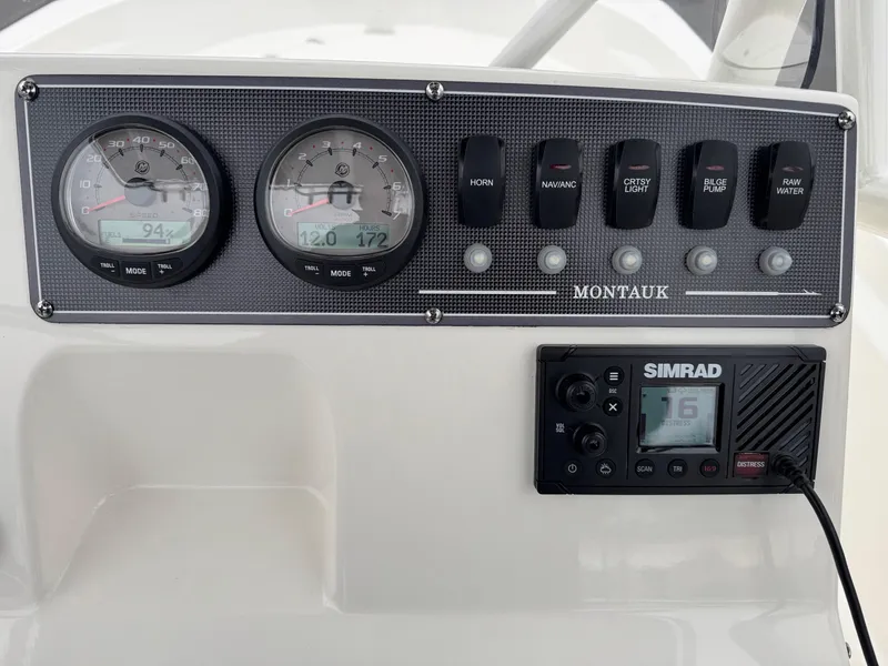 Slide: The Image of Dashboard of 2023 Boston Whaler 190 Montauk with gauges and Simrad display. - 12