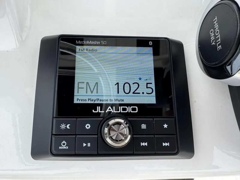 Slide: The Image of JL Audio MediaMaster 50 on 2023 Boston Whaler 190 Montauk, displaying FM 102.5. - 13