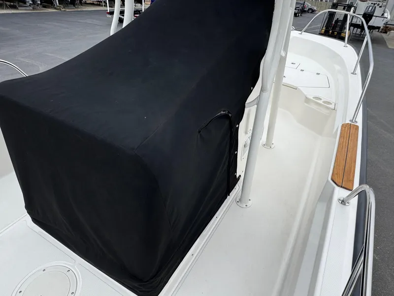 Slide: The Image of 2023 Boston Whaler 190 Montauk boat with black console cover, white deck, and railing. - 20