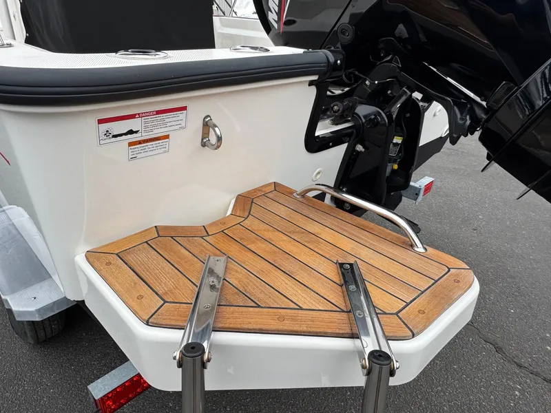 Slide: The Image of 2023 Boston Whaler 190 Montauk swim platform with wooden finish and ladder. - 21