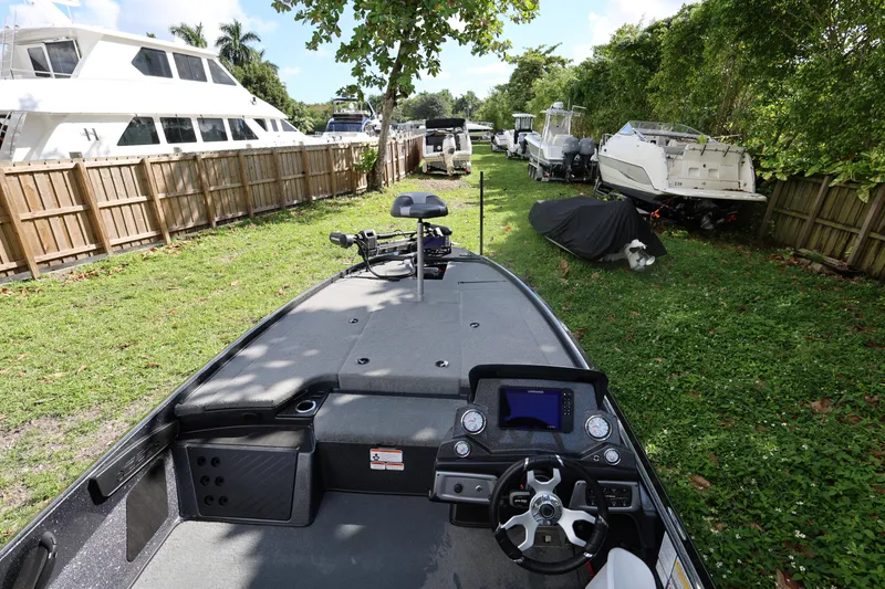 Slide: The Image of 2022 Nitro Z20 Pro boat parked on grass, surrounded by other boats and trees. - 12