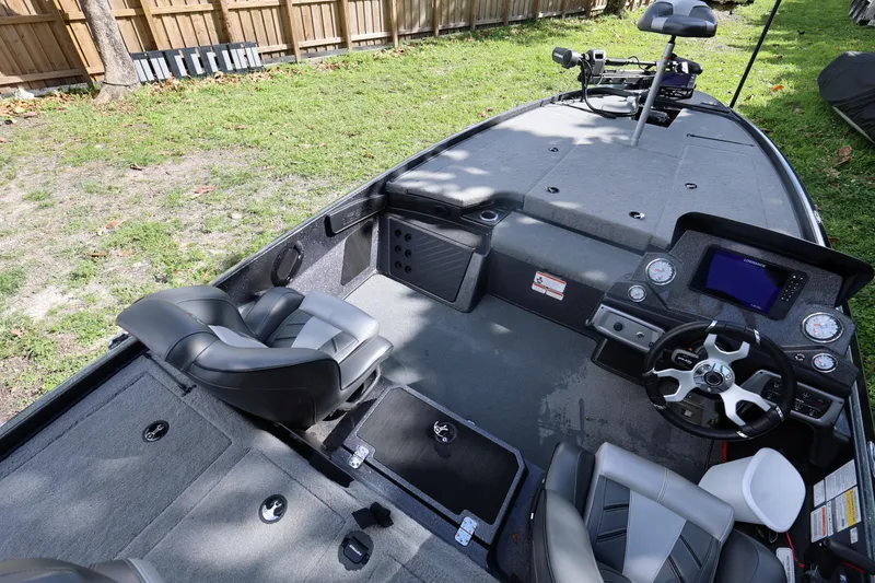 Slide: The Image of Interior of a 2022 Nitro Z20 Pro fishing boat with modern seating and controls. - 13
