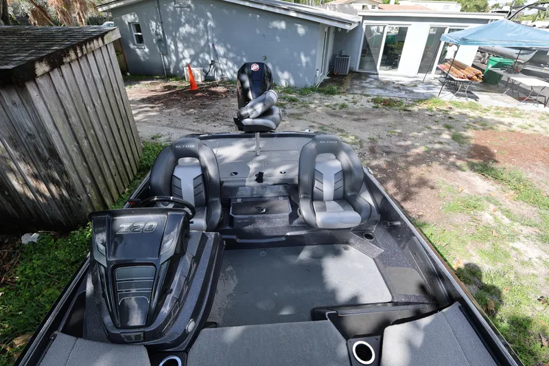 Slide: The Image of 2022 Nitro Z20 Pro boat with seating, parked outdoors near a wooden shed. - 14