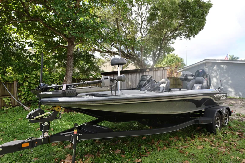 Slide: The Image of 2022 Nitro Z20 Pro fishing boat on trailer, parked in a grassy yard. - 16