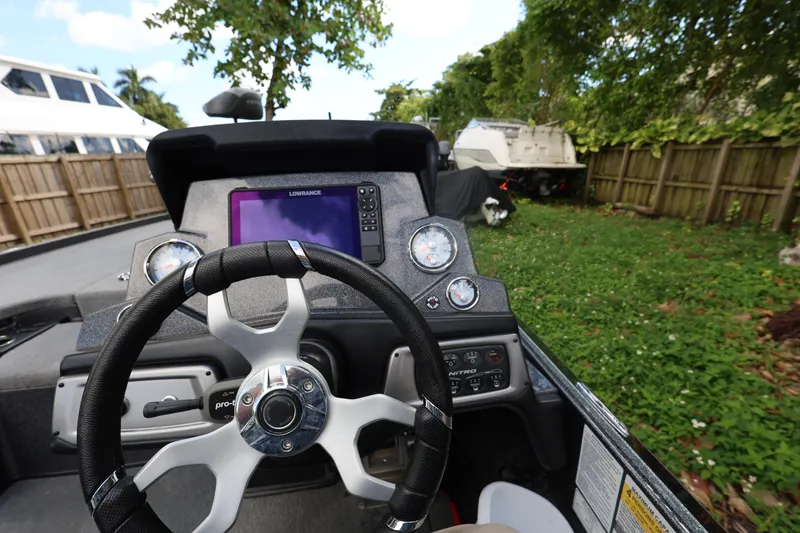 Slide: The Image of Steering wheel and dashboard of 2022 Nitro Z20 Pro boat, featuring navigation system. - 21
