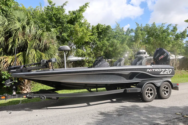 Slide: The Image of 2022 Nitro Z20 Pro boat on trailer, parked outdoors with trees in background. - 4