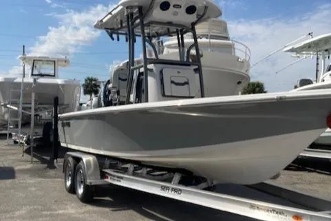 The Image of 2025 Sea Pro 230 Bay boat on trailer, parked in marina under clear sky. - 0