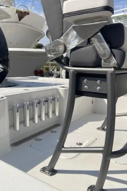 Slide: The Image of 2025 Sea Pro 230 Bay boat interior with seating and rod holders. - 4