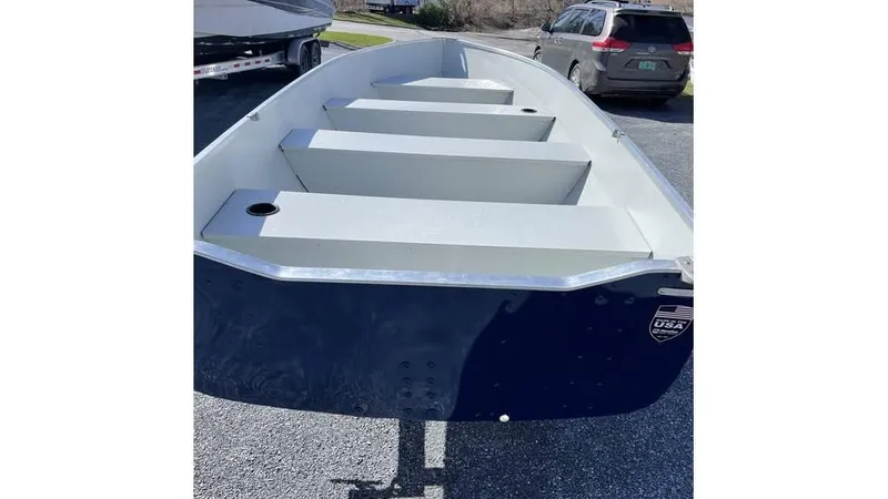 Slide: The Image of 2022 Duranautic 14 ft Yamaha Package boat, blue exterior, parked on gravel. - 3