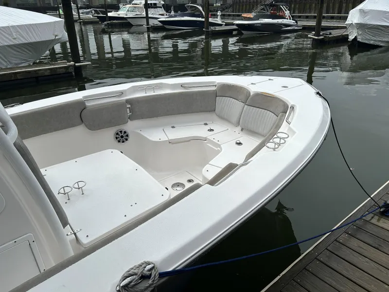 Slide: The Image of 2018 Sea Fox 266 Commander boat docked, featuring spacious seating and cup holders. - 11