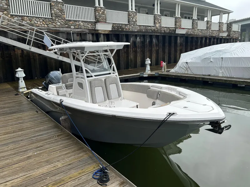 Slide: The Image of 2018 Sea Fox 266 Commander boat docked at a marina, featuring sleek design and modern amenities. - 3