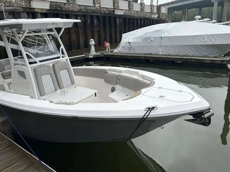 Slide: The Image of 2018 Sea Fox 266 Commander boat docked in marina, featuring sleek design and spacious seating. - 4