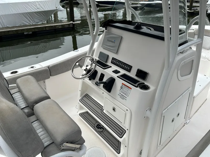 Slide: The Image of 2018 Sea Fox 266 Commander boat console with steering wheel and seating. - 9