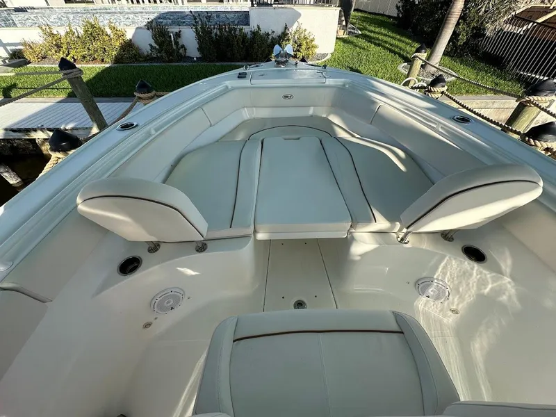 Slide: The Image of 2022 Sea Hunt Ultra 255 SE boat interior with cushioned seating and sleek design. - 10