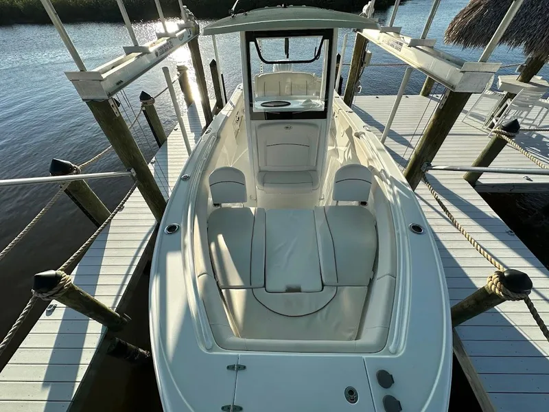 Slide: The Image of 2022 Sea Hunt Ultra 255 SE boat docked on a sunny day. - 11
