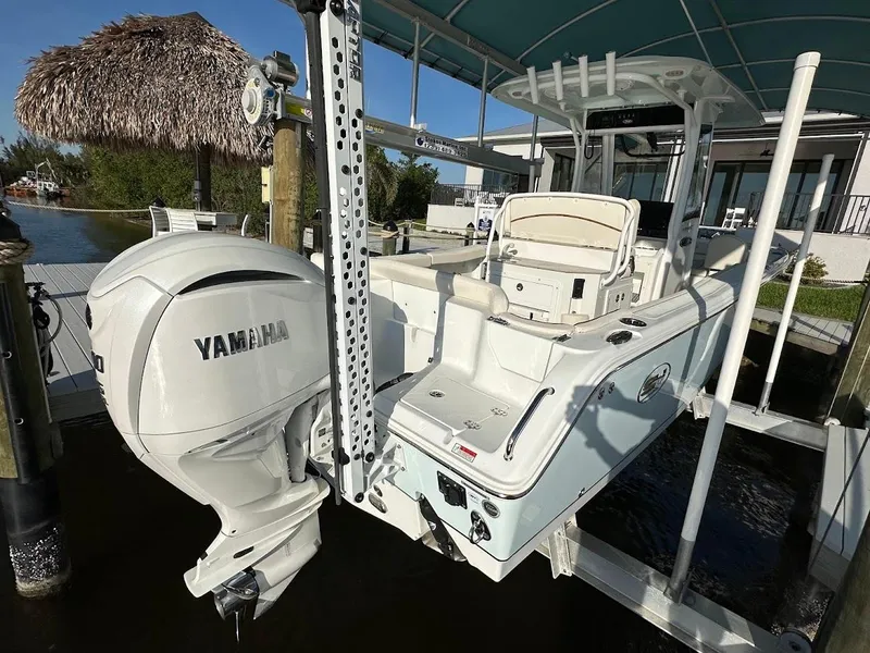 Slide: The Image of 2022 Sea Hunt Ultra 255 SE boat with Yamaha engine on a lift. - 2