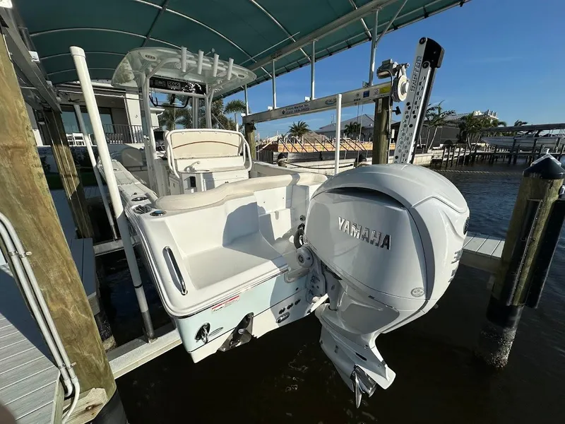 Slide: The Image of 2022 Sea Hunt Ultra 255 SE boat with Yamaha outboard motor docked under canopy. - 3