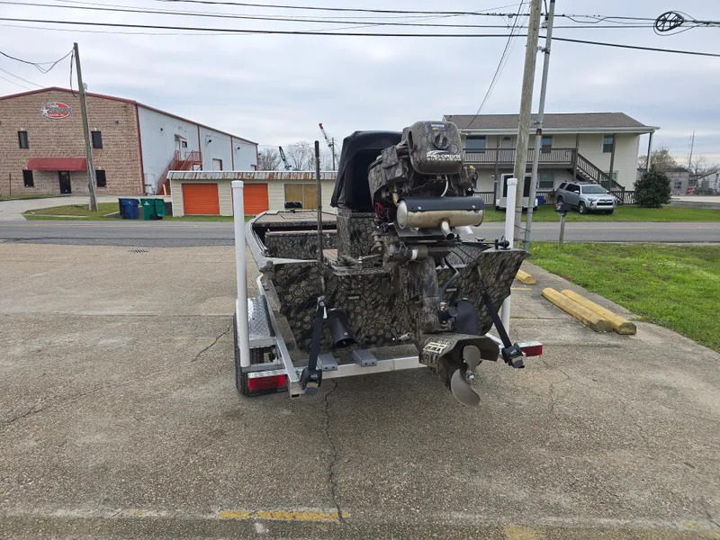 Slide: The Image of 2025 Pro-Drive 1848 SBX Stick Steer boat on trailer in parking lot. - 3