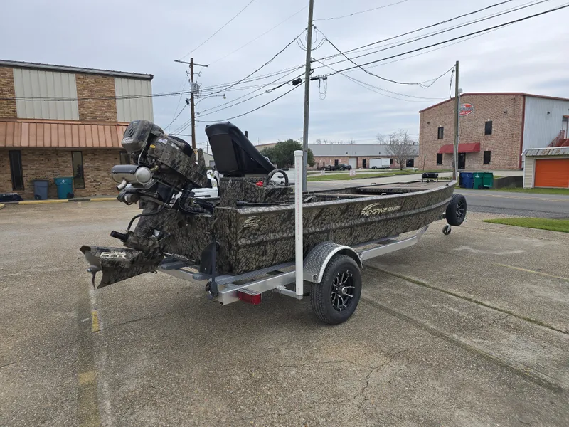 Slide: The Image of 2025 Pro-Drive 1848 SBX Stick Steer boat on trailer in parking lot. - 4