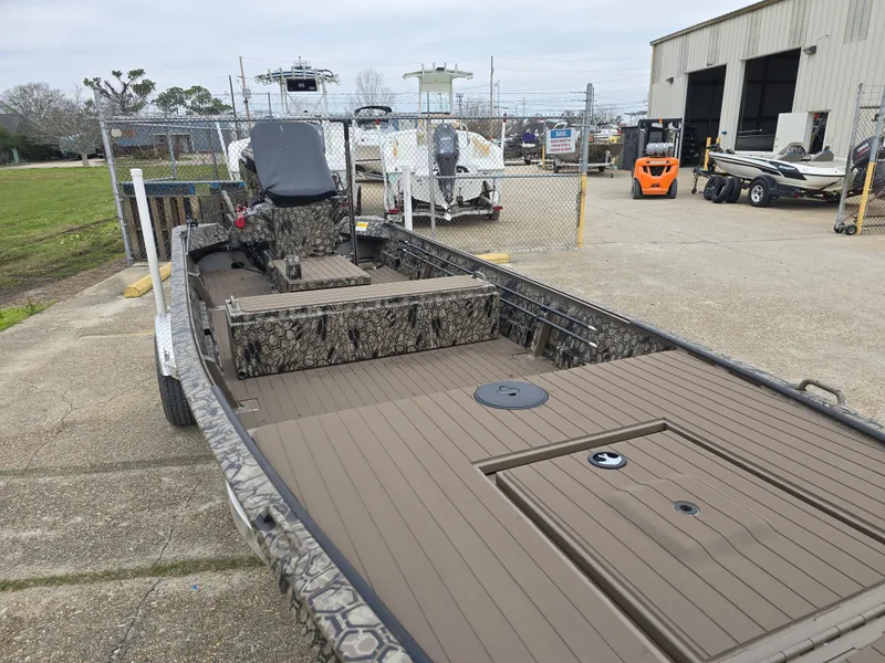 Slide: The Image of 2025 Pro-Drive 1848 SBX Stick Steer boat in a dealership lot. - 7