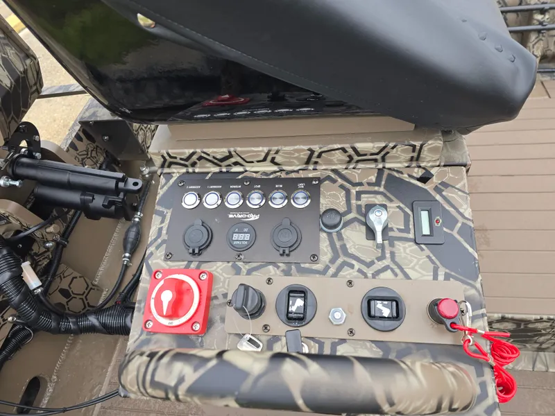 Slide: The Image of Control panel of 2025 Pro-Drive 1848 SBX Stick Steer boat with camouflage design. - 9