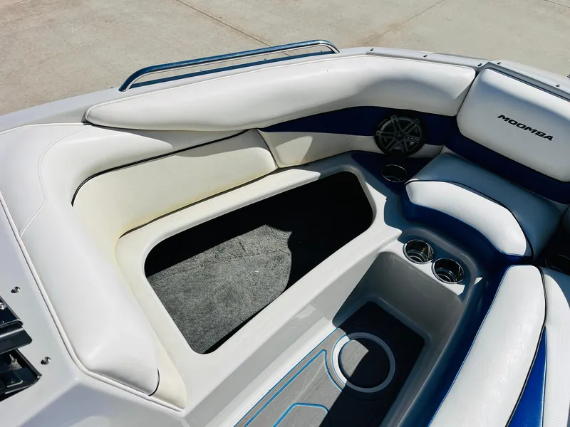 Slide: The Image of 2012 Moomba Mojo 2.5 boat interior with white and blue seating and cup holders. - 13