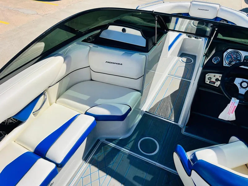 Slide: The Image of 2012 Moomba Mojo 2.5 boat interior with white and blue seating, modern dashboard. - 17