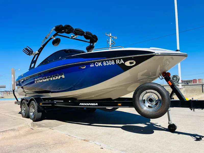Slide: The Image of 2012 Moomba Mojo 2.5 boat on trailer, blue and white, sunny day. - 2
