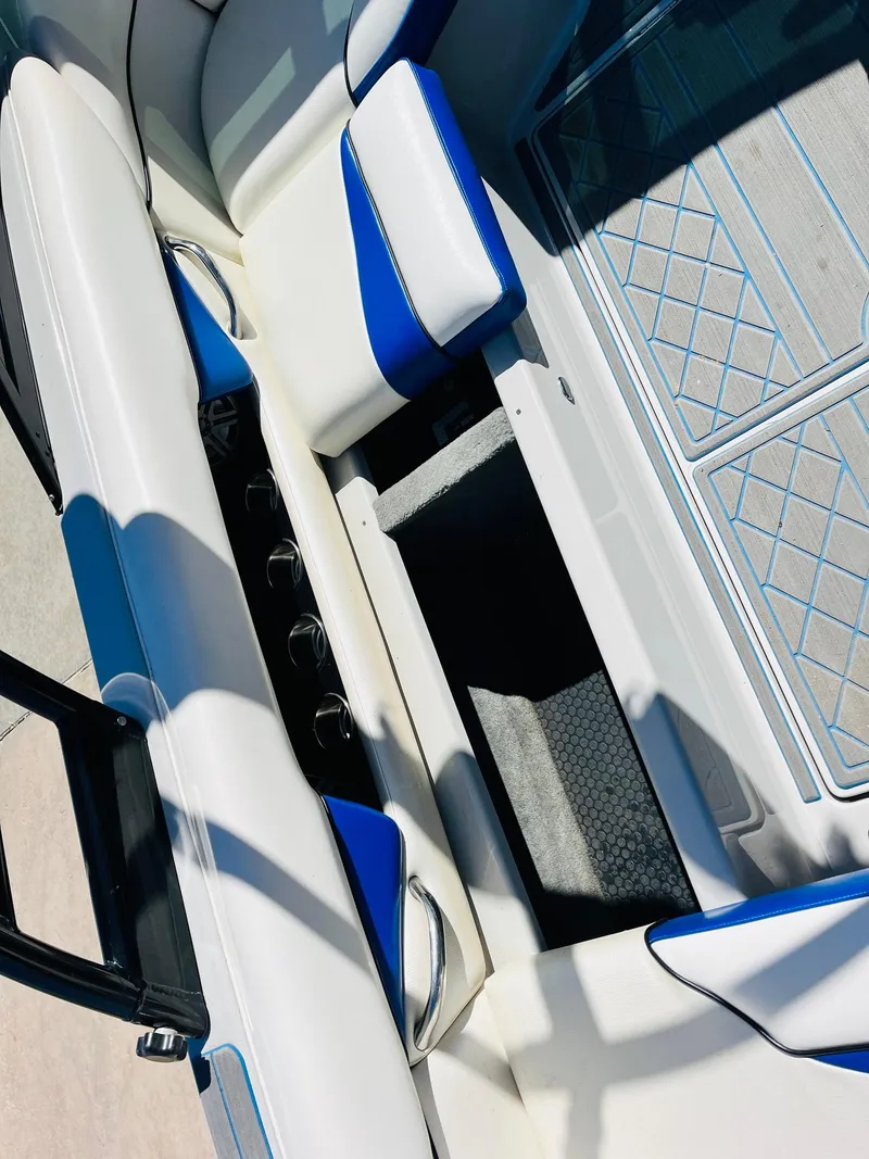Slide: The Image of 2012 Moomba Mojo 2.5 boat interior with white and blue seating. - 23