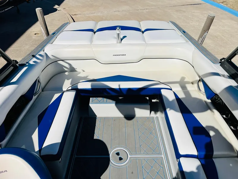 Slide: The Image of 2012 Moomba Mojo 2.5 boat interior with blue and white seating. - 24
