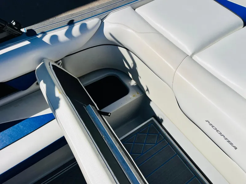 Slide: The Image of 2012 Moomba Mojo 2.5 boat interior with open storage compartment and cushioned seating. - 26