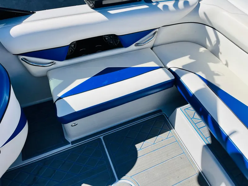 Slide: The Image of 2012 Moomba Mojo 2.5 boat interior with blue and white seating. - 27