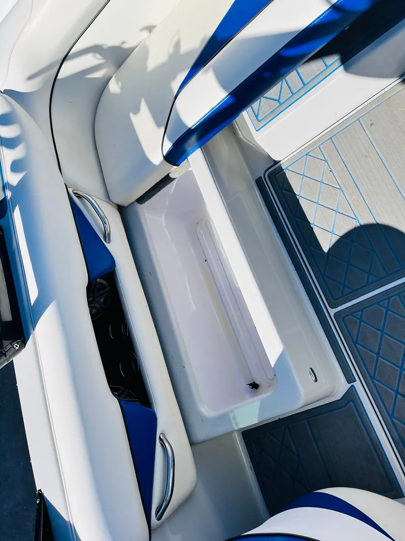 Slide: The Image of 2012 Moomba Mojo 2.5 boat interior with open storage compartment and blue accents. - 28