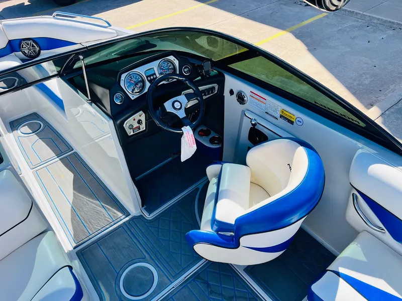 Slide: The Image of 2012 Moomba Mojo 2.5 boat interior with blue and white seating and dashboard. - 29