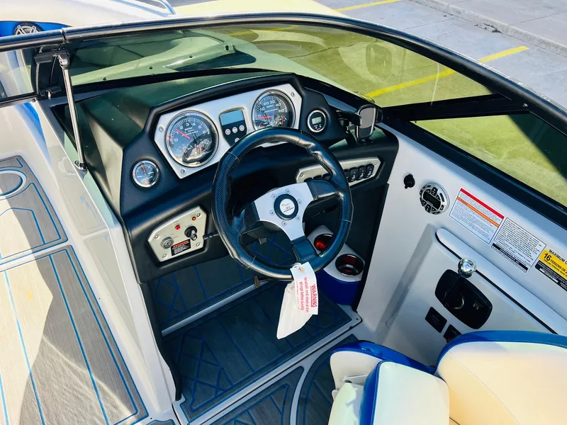 Slide: The Image of 2012 Moomba Mojo 2.5 boat dashboard with steering wheel and gauges. - 32