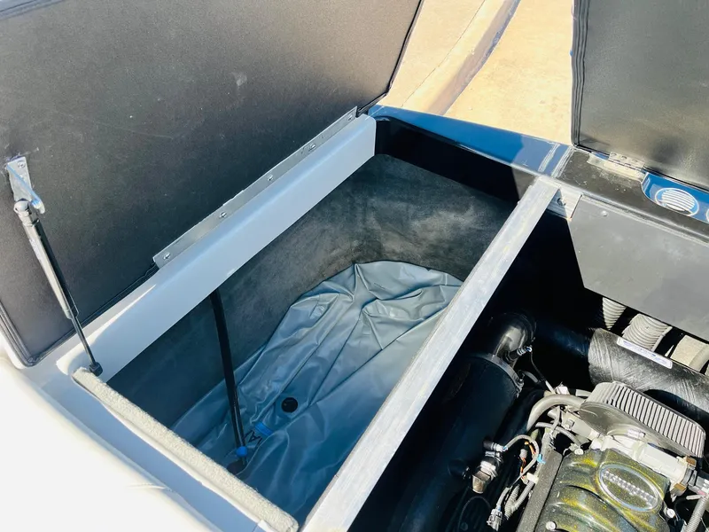 Slide: The Image of 2012 Moomba Mojo 2.5 engine compartment with open storage area. - 35