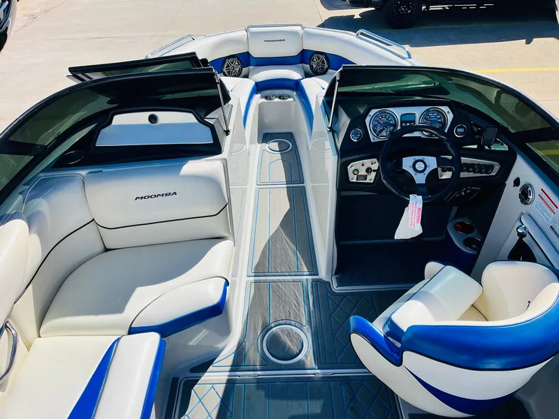 Slide: The Image of 2012 Moomba Mojo 2.5 boat interior with white and blue seating, dashboard, and steering wheel. - 9