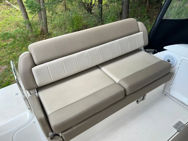 Slide: The Image of 2013 Regal 30 Express boat seating, beige upholstery, outdoor setting. - 10