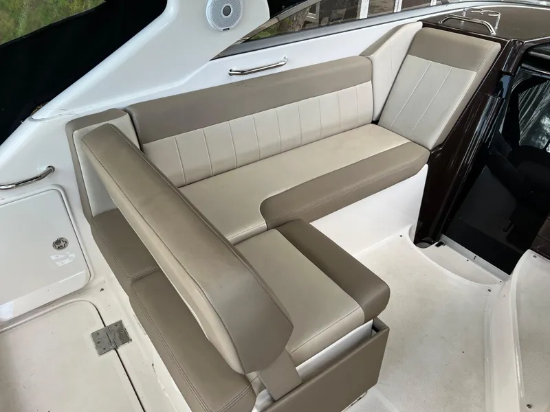 Slide: The Image of 2013 Regal 30 Express boat interior seating with beige upholstery. - 12