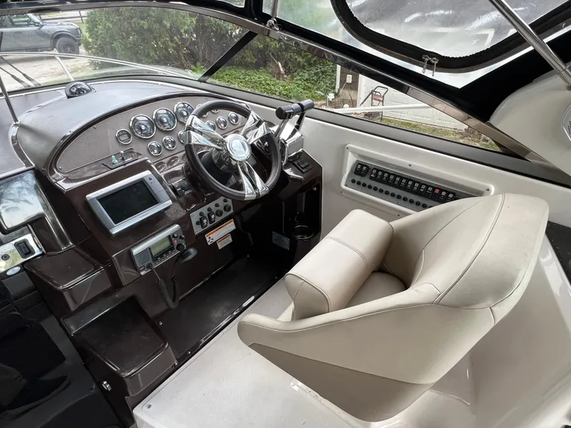 Slide: The Image of Interior cockpit of a 2013 Regal 30 Express boat, featuring steering wheel and control panel. - 13
