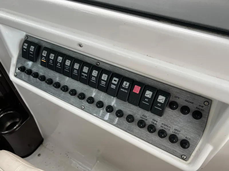 Slide: The Image of Control panel of a 2013 Regal 30 Express boat with labeled switches and buttons. - 16