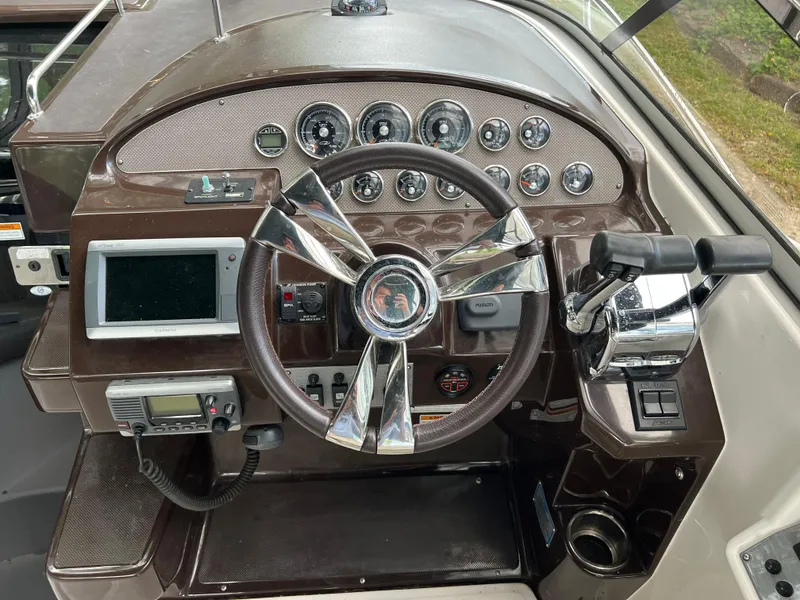 Slide: The Image of 2013 Regal 30 Express boat dashboard with steering wheel and control panel. - 17