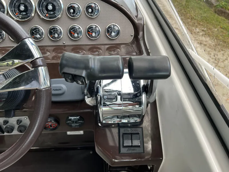 Slide: The Image of Control panel of 2013 Regal 30 Express boat with steering wheel and throttle levers. - 18