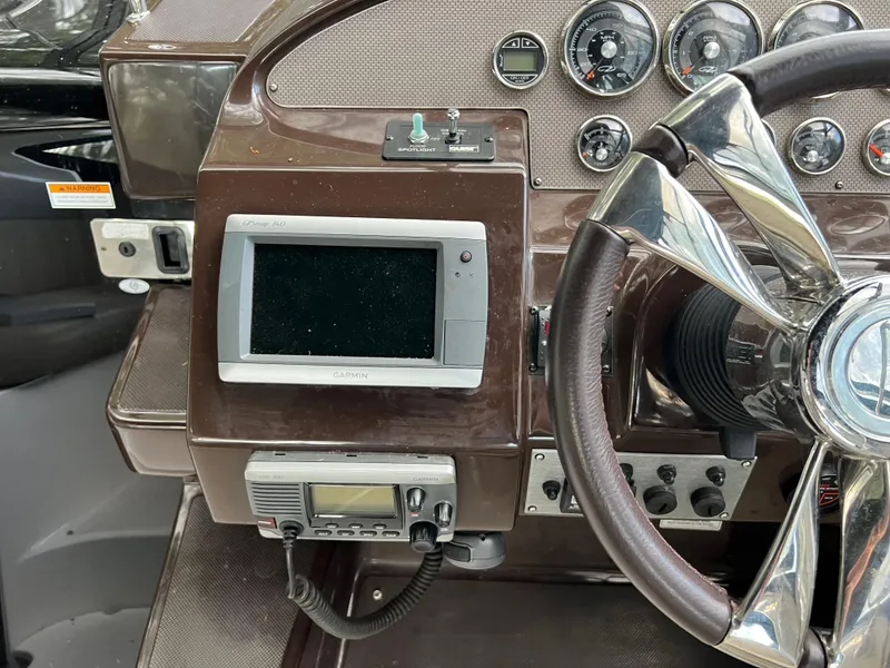 Slide: The Image of Dashboard of a 2013 Regal 30 Express boat with steering wheel and navigation instruments. - 19
