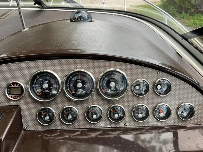 Slide: The Image of Dashboard of a 2013 Regal 30 Express boat with multiple gauges and controls. - 20