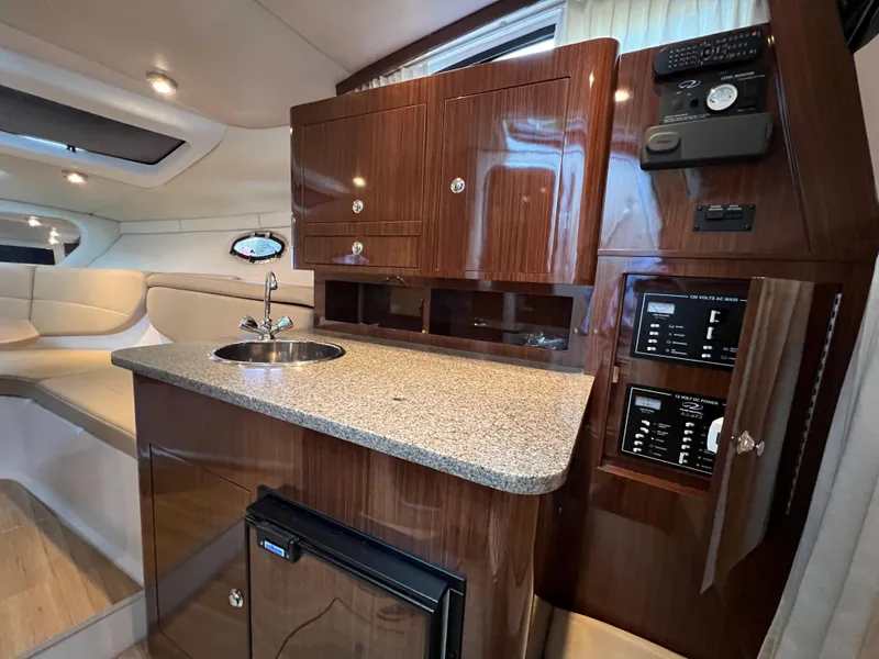 Slide: The Image of Luxurious interior of 2013 Regal 30 Express yacht with kitchenette and seating area. - 25