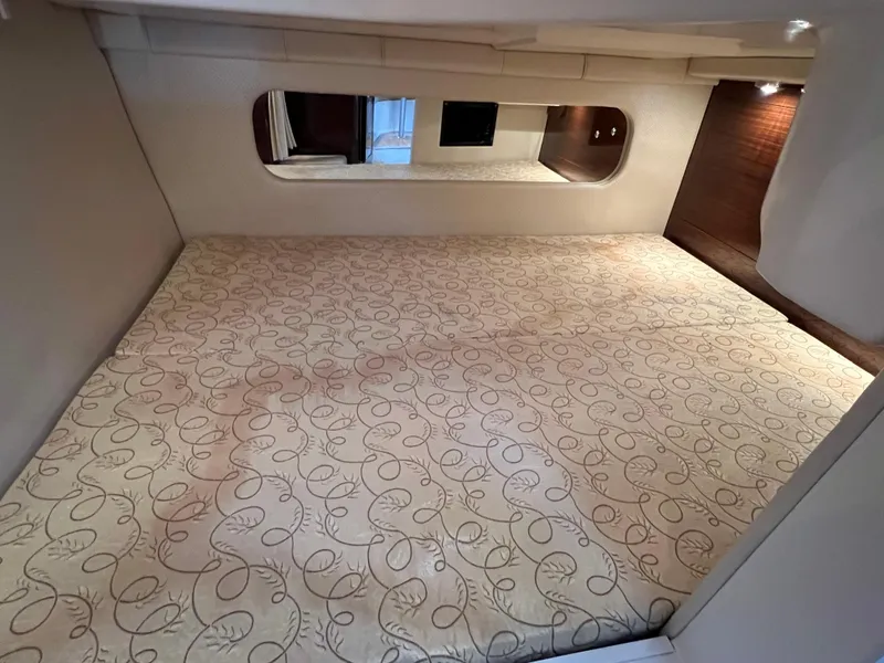 Slide: The Image of 2013 Regal 30 Express cabin interior with patterned bedding and modern design. - 29