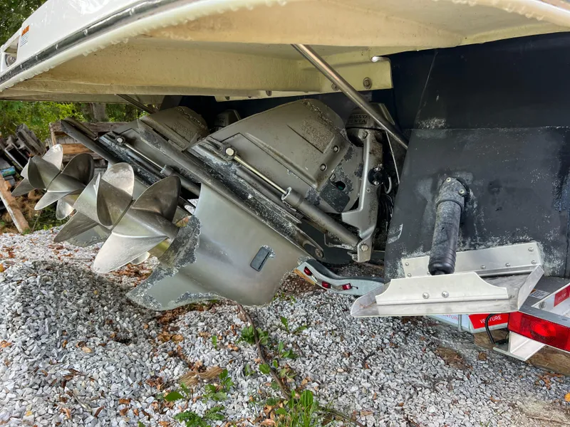 Slide: The Image of 2013 Regal 30 Express boat stern drive and propellers on gravel. - 3