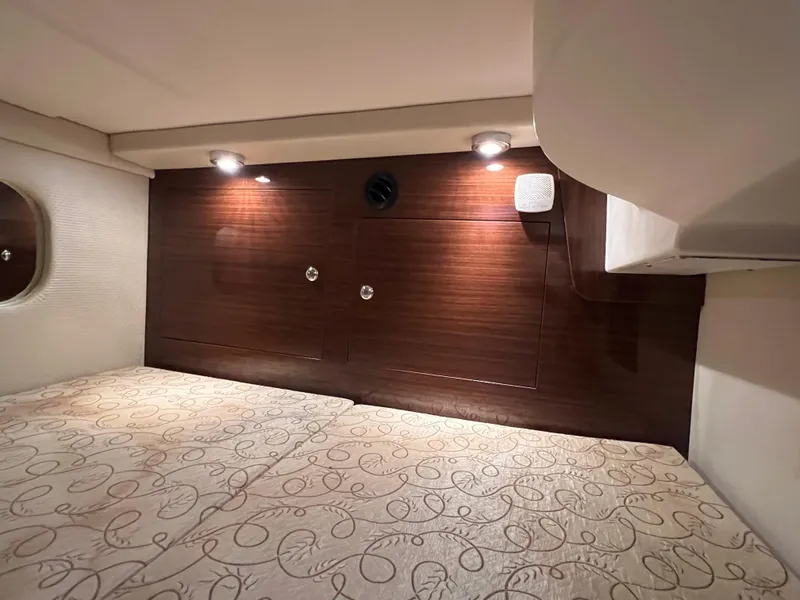 Slide: The Image of 2013 Regal 30 Express cabin interior with wood paneling and ambient lighting. - 30